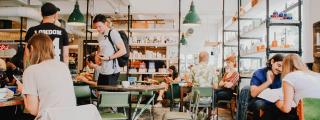 Banner zeigt Situation in Kaffeehaus mit jungen Menschen